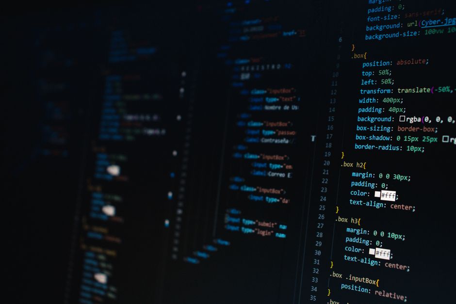 Student reviewing Python automation script on a laptop
